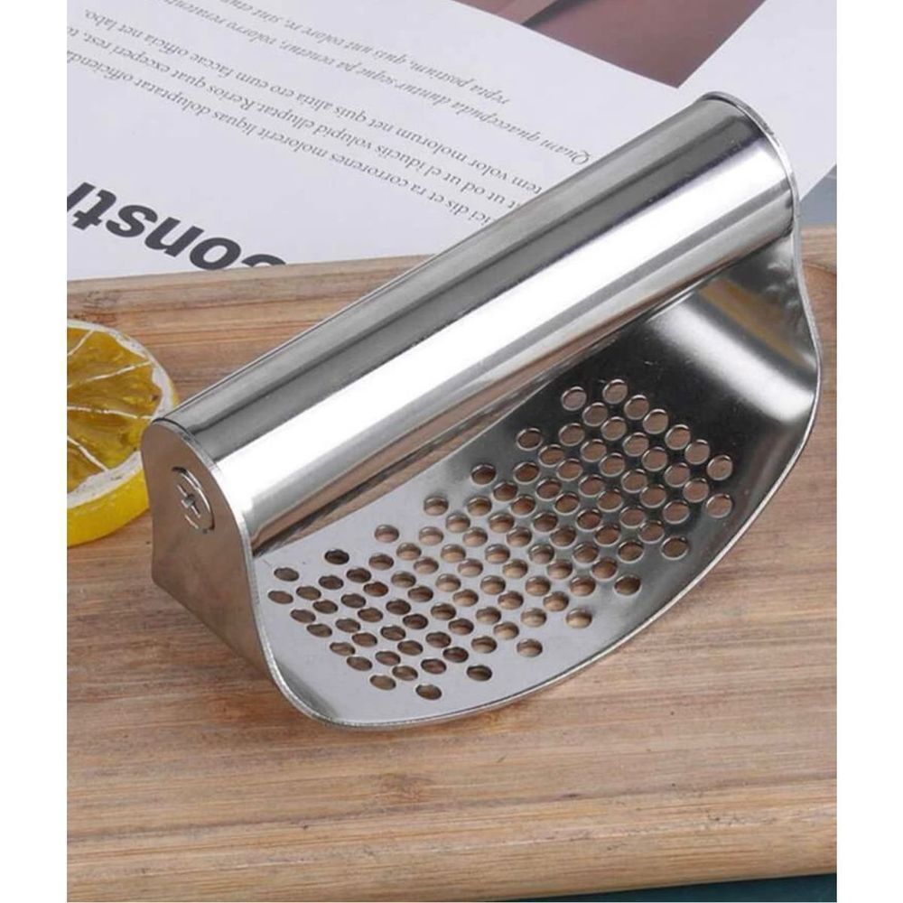 ￼ Stainless steel, garlic press, kitchen tool